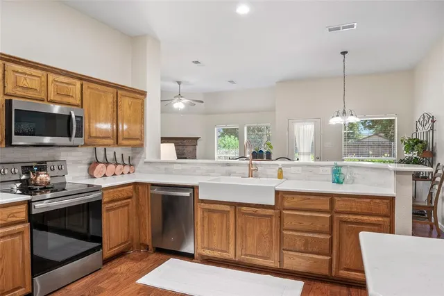 a kitchen with a sink stove and microwave