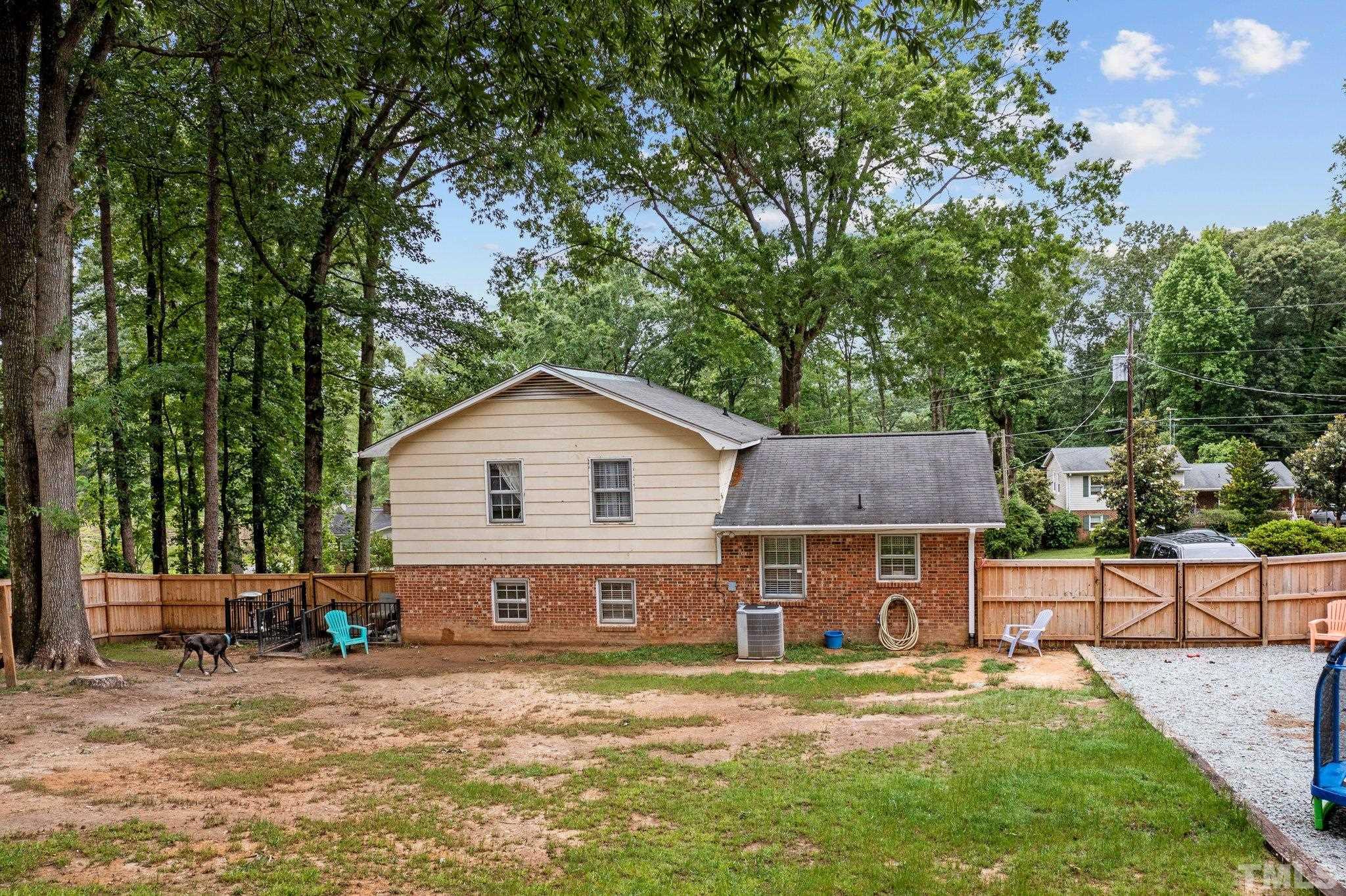 1225 Dover Street Roxboro, NC 27573 - Photo 8 of 37 a view of a house with a yard and large tree