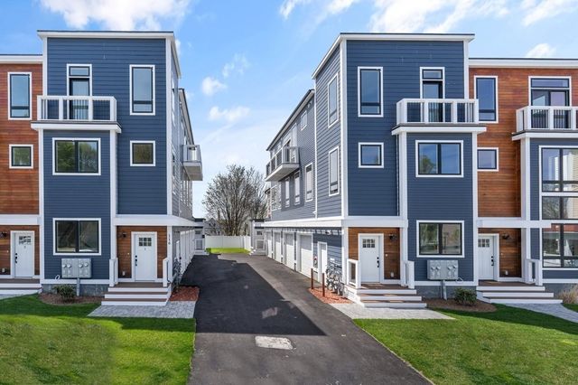a front view of a building with a yard