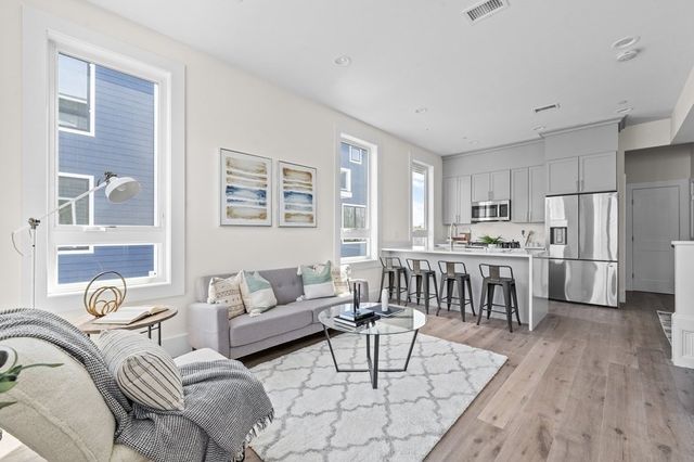 a bedroom with furniture and a wooden floor