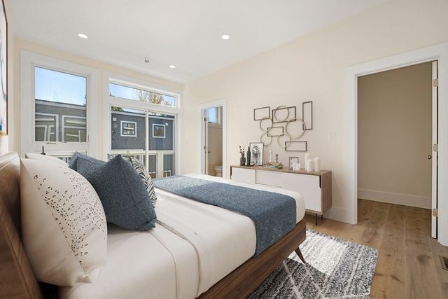 a bedroom with a large bed and a window