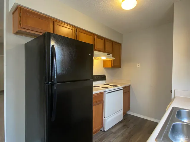 a kitchen with metallic refrigerator freezer and a dishwasher