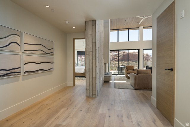 214 Lionsback Loop, Unit 37 Moab, UT 84532 - Photo 4 of 21 Open-concept living area with vaulted wood-panel ceilings, floor-to-ceiling windows, and light wood-finish flooring