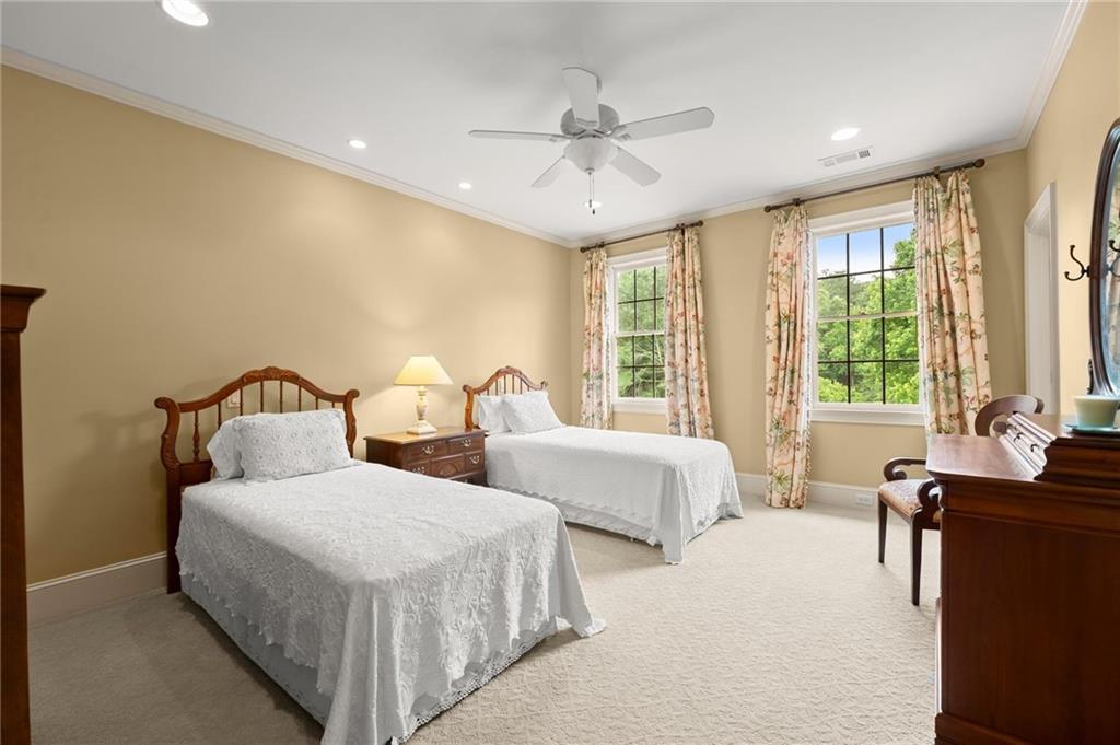 322 Edwards Brook Lane Canton, GA 30115 - Photo 64 of 99 a spacious bedroom with two beds and a large window