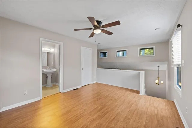 a view of a livingroom with a window and a ceiling fan