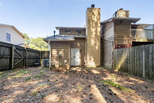 a view of a house with wooden fence