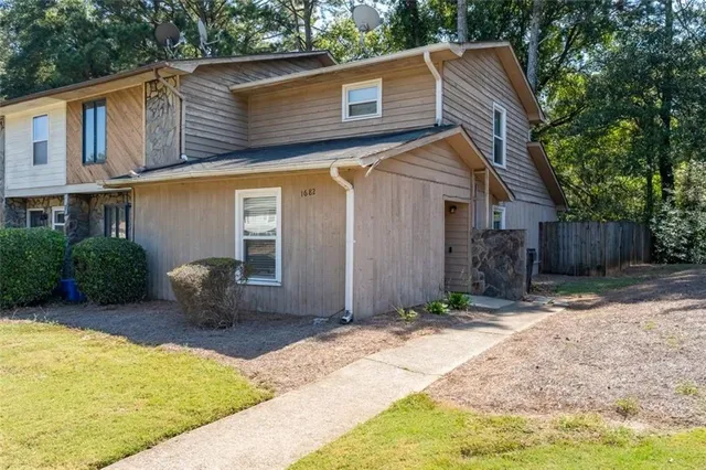 a front view of a house with garden