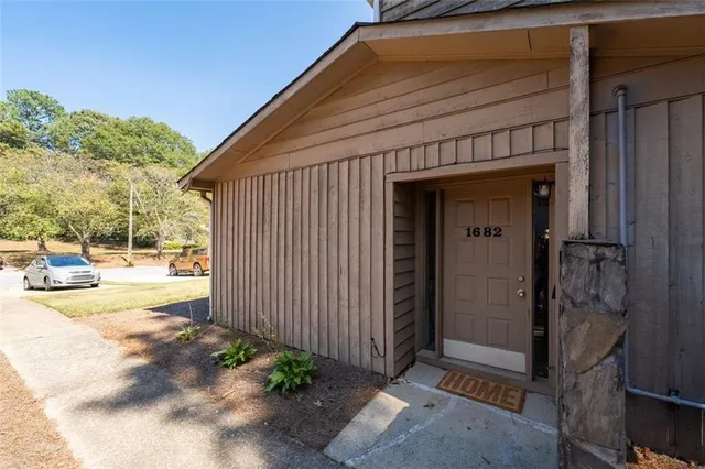 a view of a house with backyard and sitting area