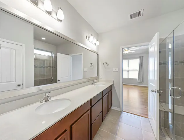 a bathroom with a tub sink and mirror