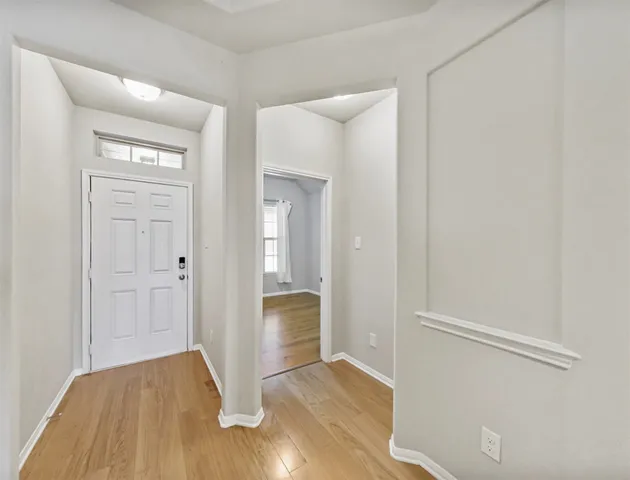 an empty room with wooden floor and closet