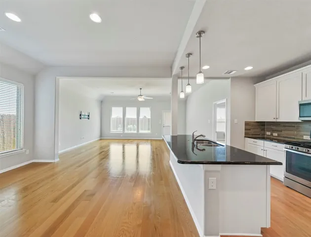 a view of kitchen with sink and wooden floor
