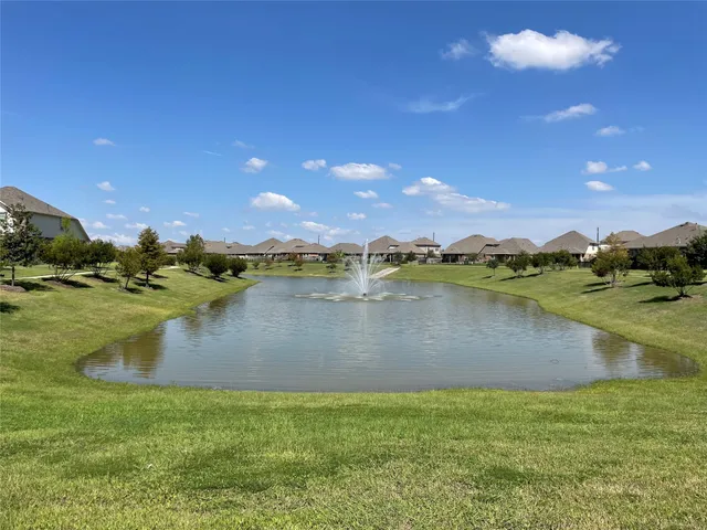 a view of a lake with houses in the back