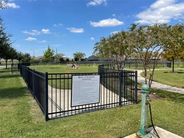 a view of a wrought iron fences with a park