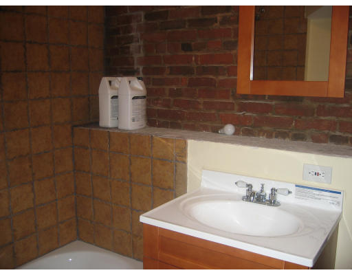 19 Emerson Street, Unit 1 Boston, MA 02127 - Photo 6 of 14 a bathroom with a sink and a mirror