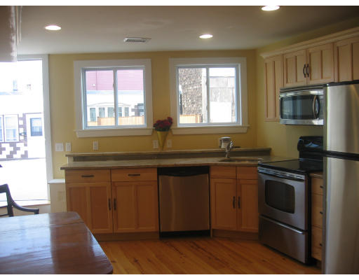 19 Emerson Street, Unit 1 Boston, MA 02127 - Photo 9 of 14 a kitchen with granite countertop a stove a sink and a microwave