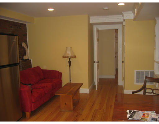 19 Emerson Street, Unit 1 Boston, MA 02127 - Photo 10 of 14 a living room with furniture and a wooden floor