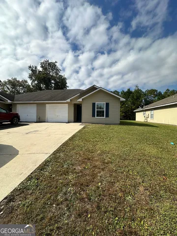 a view of house with yard and ocean view