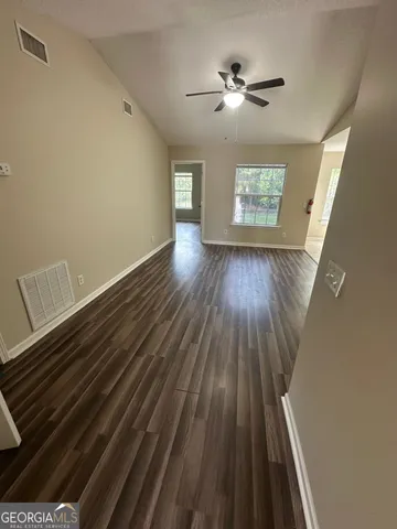 wooden floor in an empty room with a window