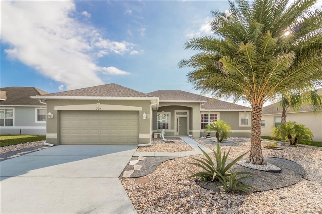 304 Wildflower Road Davenport, FL 33837 - Photo 1 of 1 a front view of a house with garden