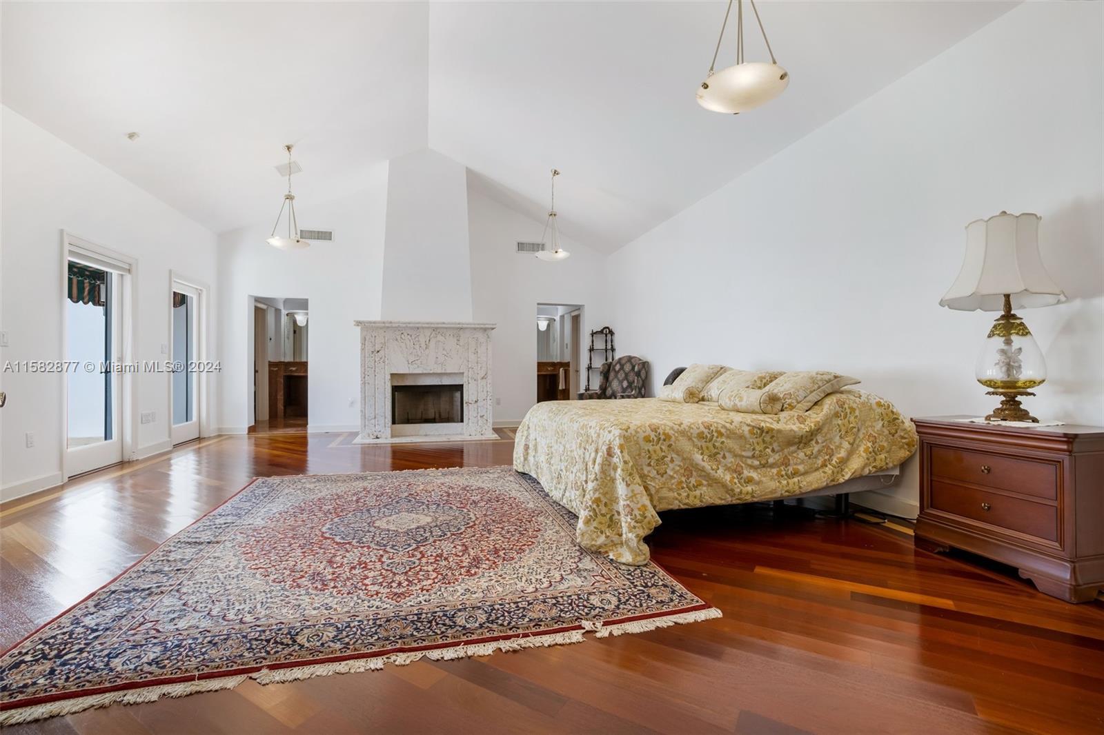 431 Costanera Road Coral Gables, FL 33143 - Photo 14 of 33 a bedroom with a bed and a fireplace