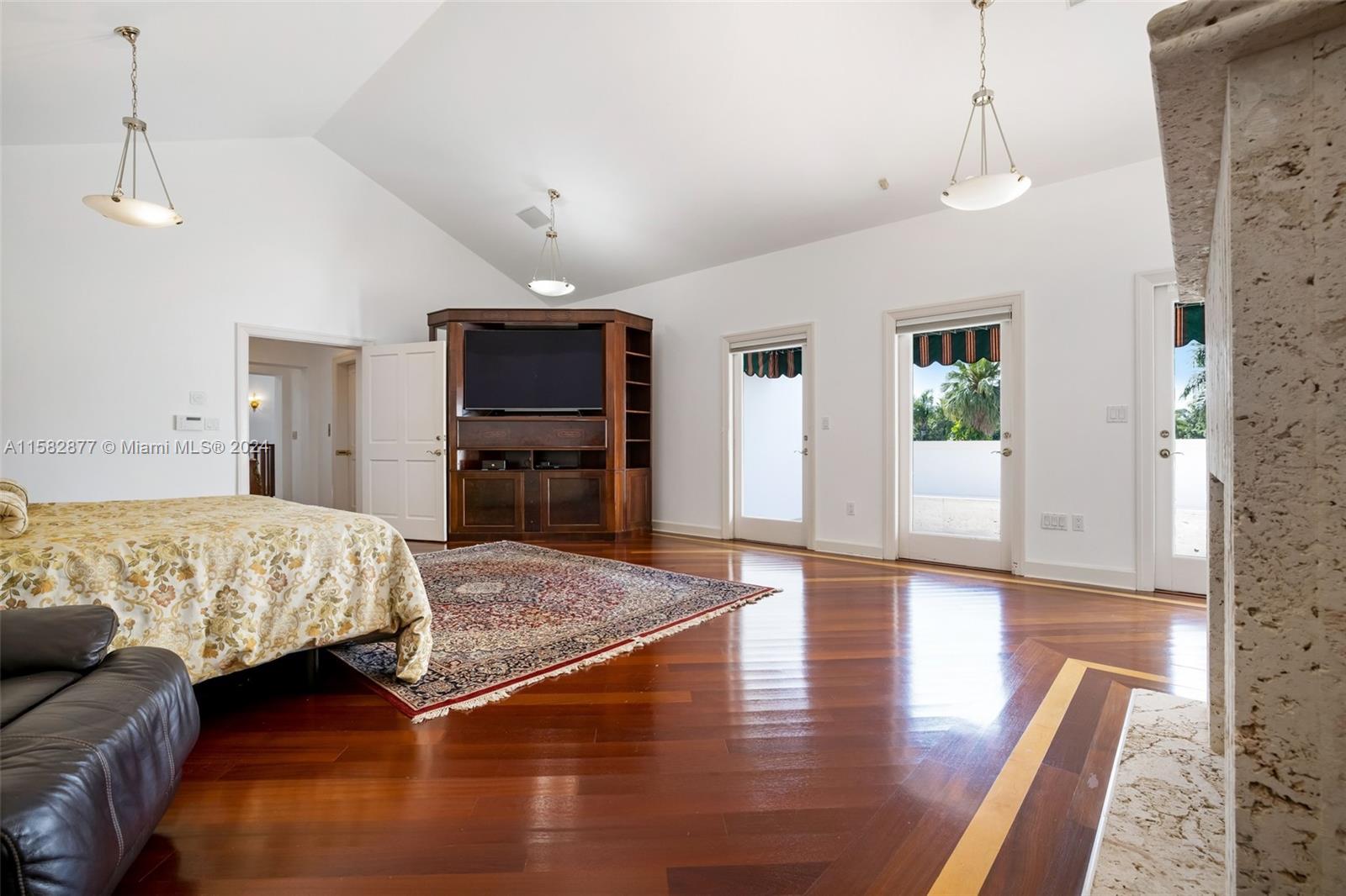 431 Costanera Road Coral Gables, FL 33143 - Photo 15 of 33 a spacious bedroom with a bed and wooden floor