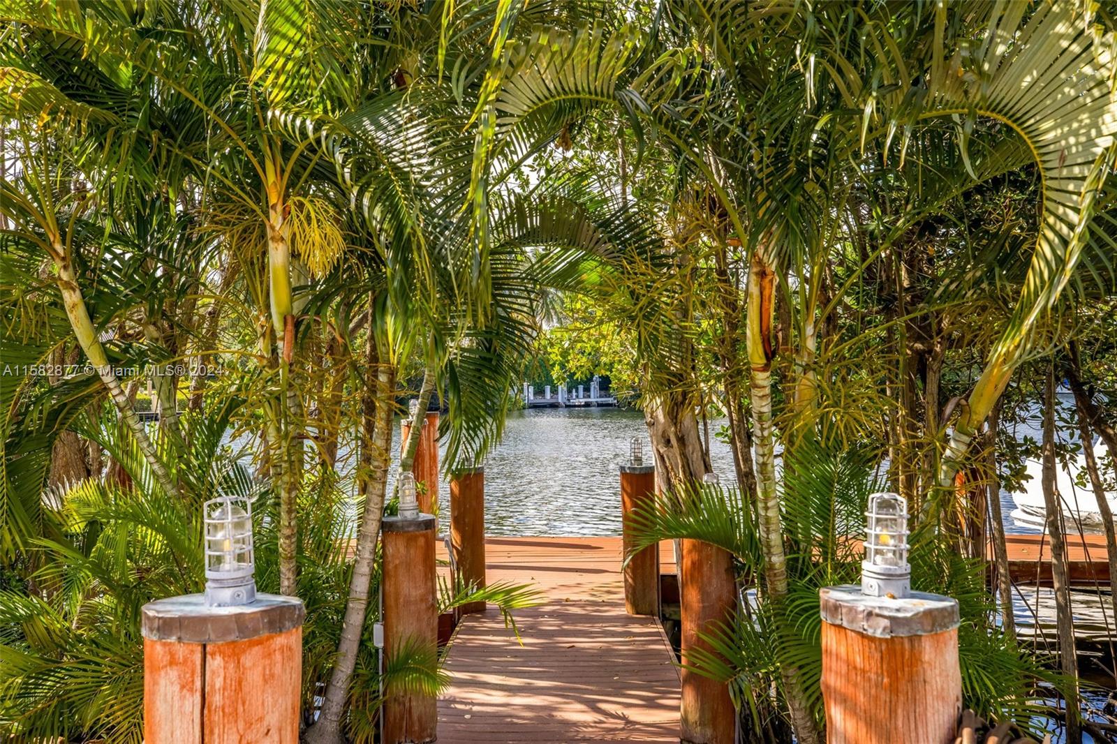 431 Costanera Road Coral Gables, FL 33143 - Photo 29 of 33 a backyard of a house with table and chairs
