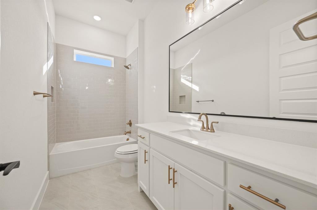 412 Caprock Lane Azle, TX 76020 - Photo 28 of 40 a bathroom with a double vanity sink toilet and shower
