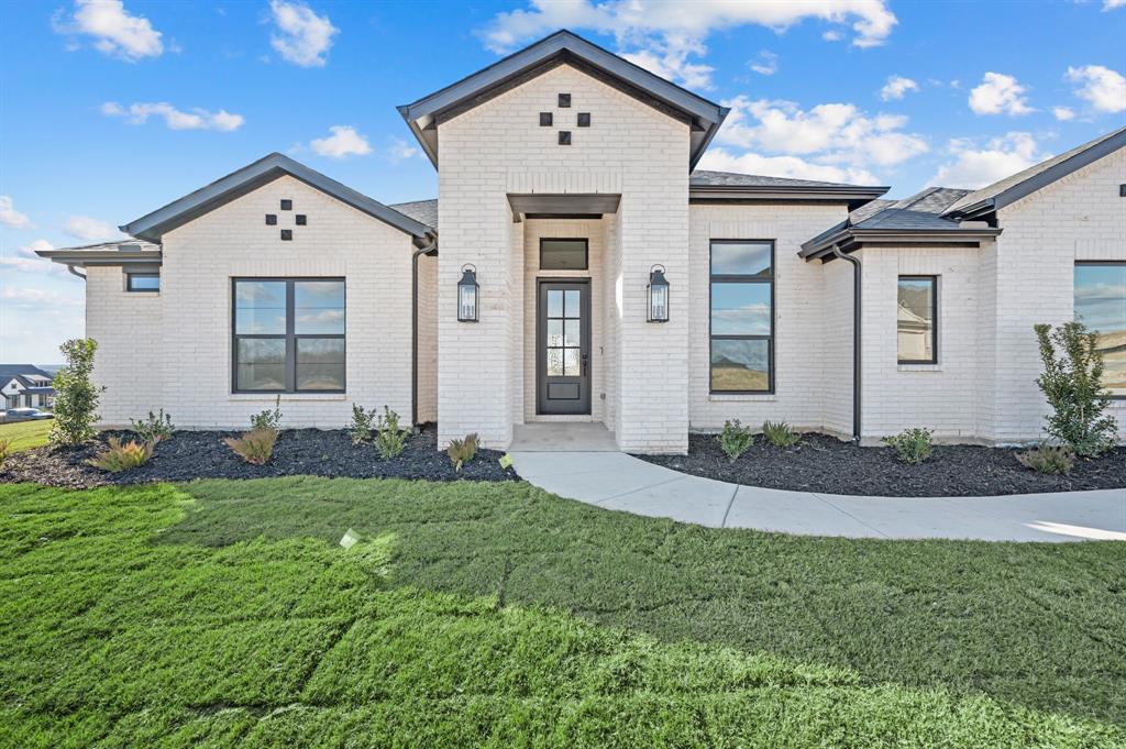 412 Caprock Lane Azle, TX 76020 - Photo 3 of 40 a front view of a house with a yard and garage