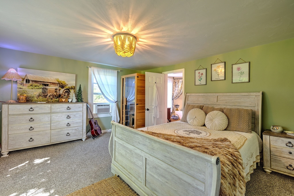 43 Rufus Putnam Road North Brookfield, MA 01535 - Photo 20 of 42 a bedroom with a bed and a chandelier
