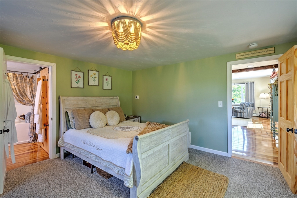 43 Rufus Putnam Road North Brookfield, MA 01535 - Photo 21 of 42 a bedroom with a bed and a chandelier