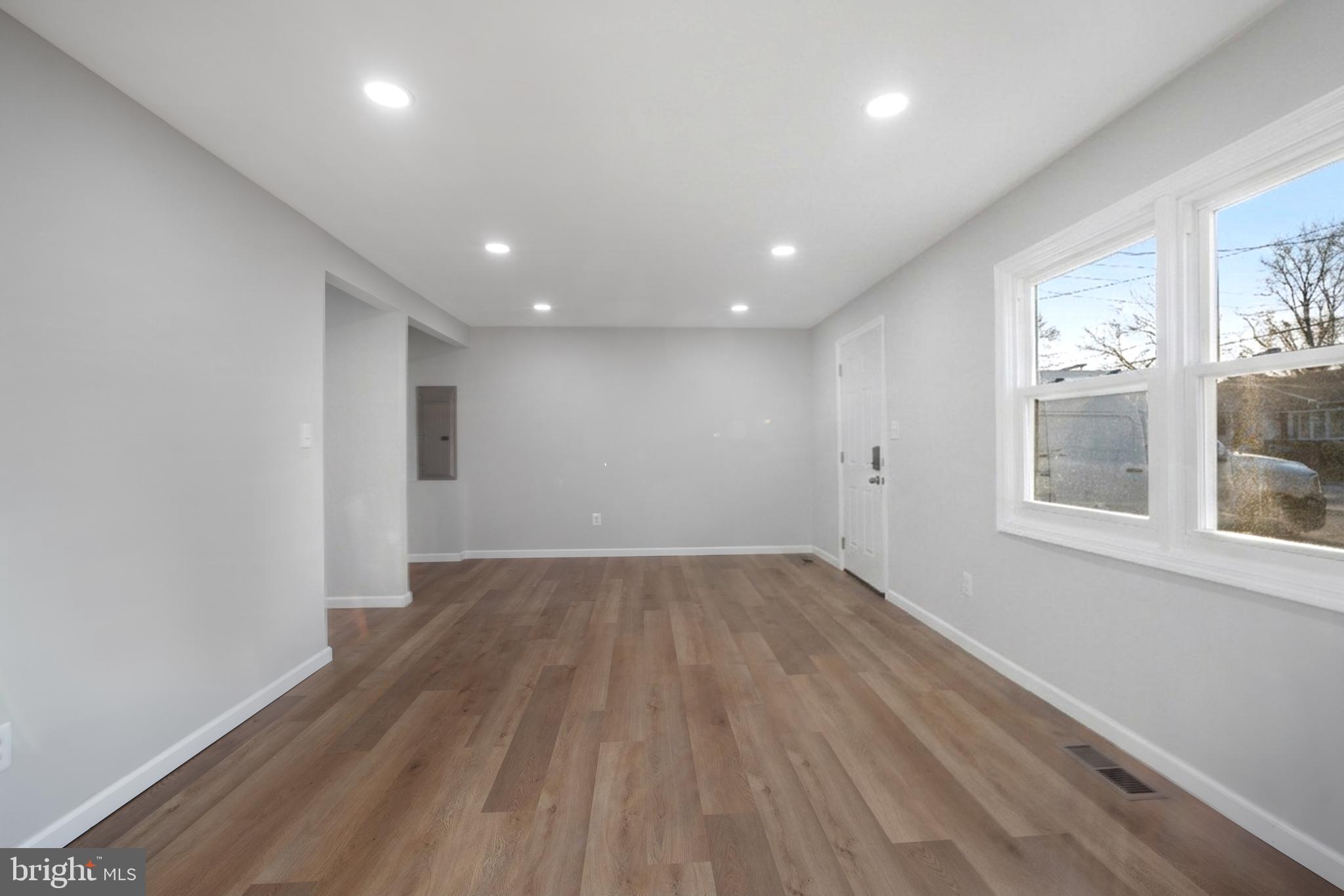 497 Bruce Avenue Odenton, MD 21113 - Photo 12 of 38 an empty room with wooden floor and windows