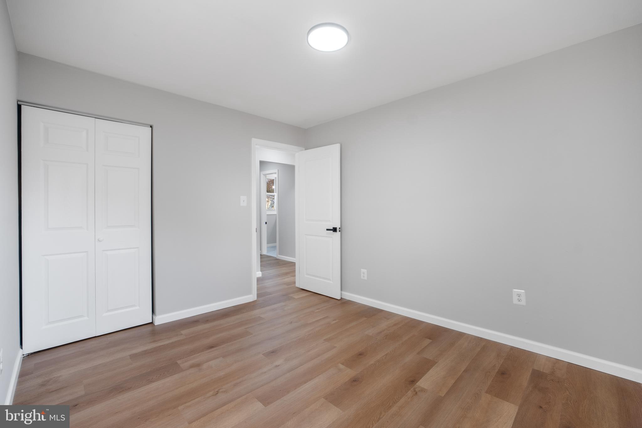 497 Bruce Avenue Odenton, MD 21113 - Photo 16 of 38 a view of an empty room with wooden floor