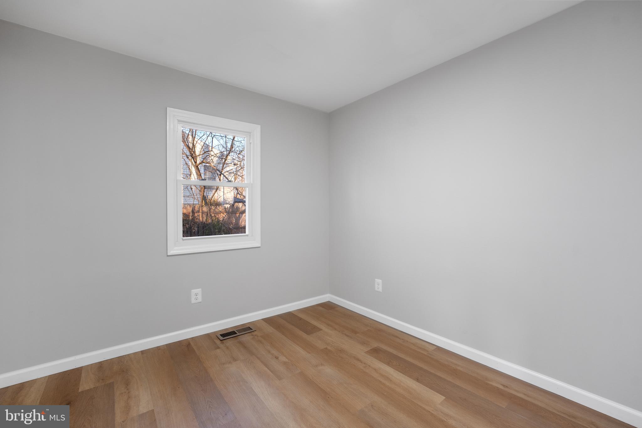 497 Bruce Avenue Odenton, MD 21113 - Photo 17 of 38 a view of an empty room with wooden floor and a window