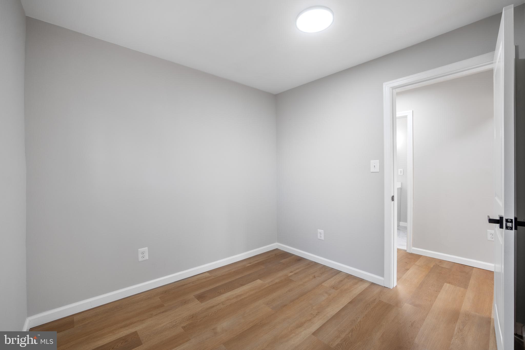 497 Bruce Avenue Odenton, MD 21113 - Photo 18 of 38 a view of an empty room with wooden floor