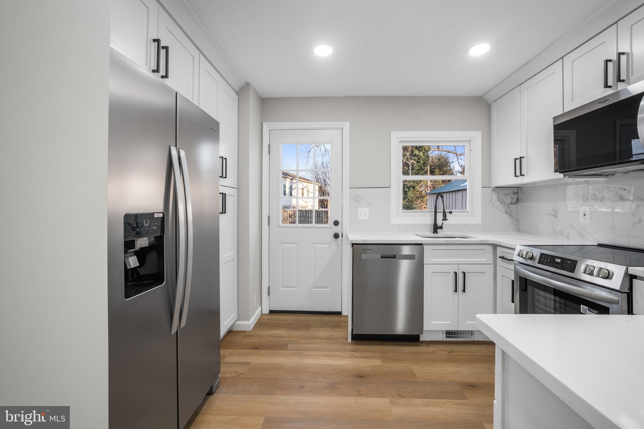 497 Bruce Avenue Odenton, MD 21113 - Photo 2 of 38 a kitchen with a sink stainless steel appliances and cabinets