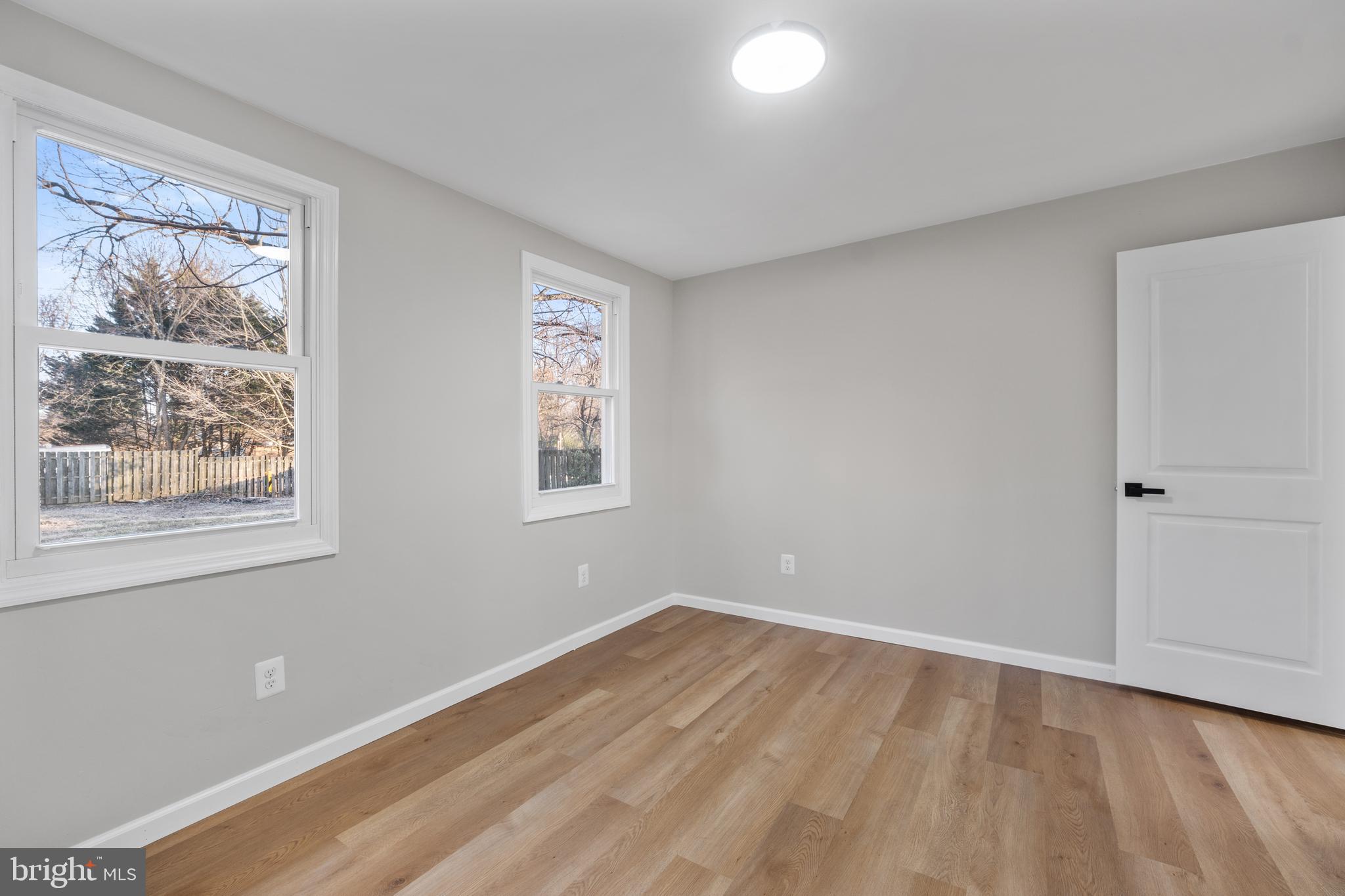 497 Bruce Avenue Odenton, MD 21113 - Photo 23 of 38 wooden floor in an empty room with a window