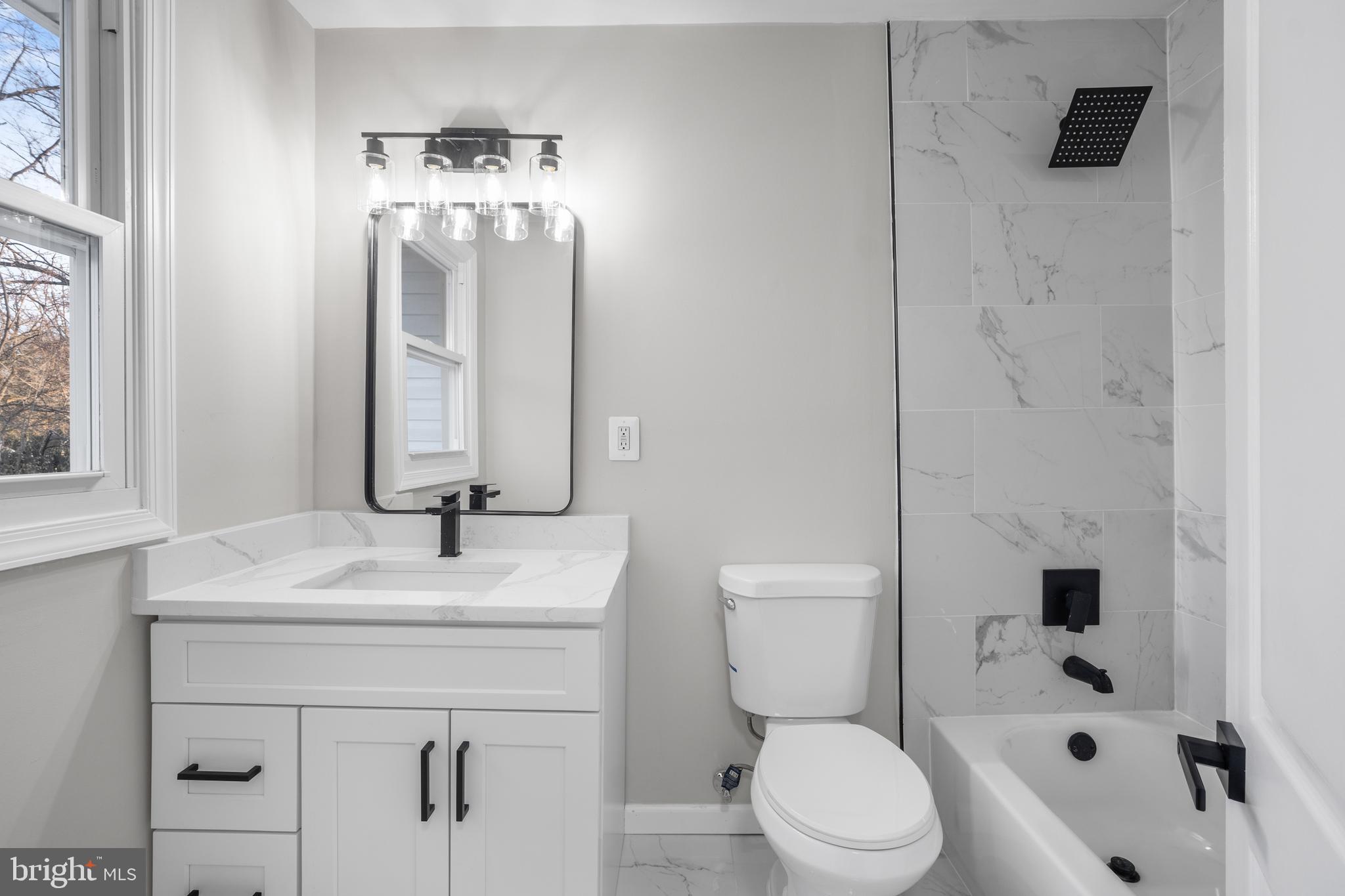 497 Bruce Avenue Odenton, MD 21113 - Photo 25 of 38 a bathroom with a sink a toilet and shower