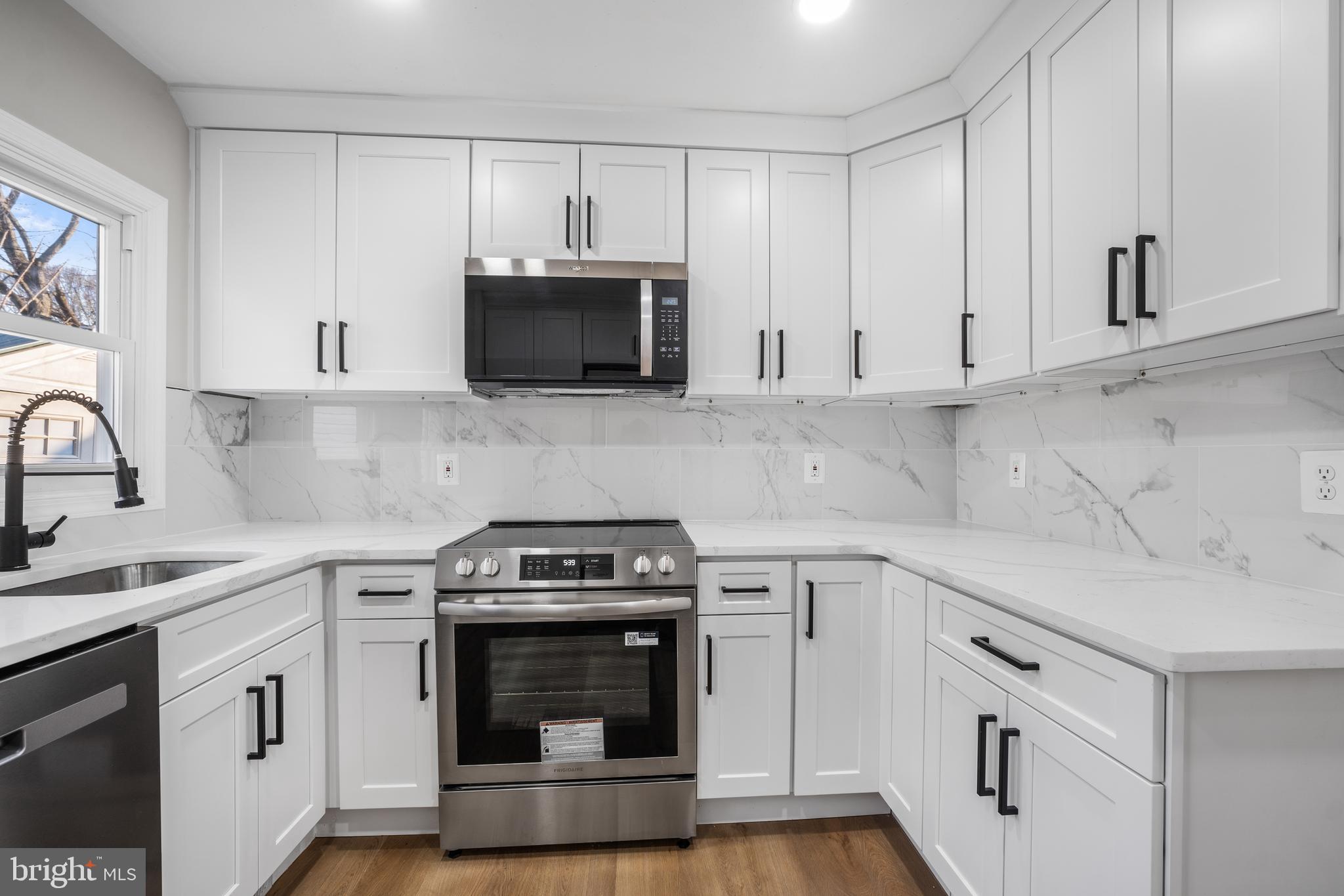 497 Bruce Avenue Odenton, MD 21113 - Photo 3 of 38 a kitchen with cabinets stainless steel appliances a sink and a stove