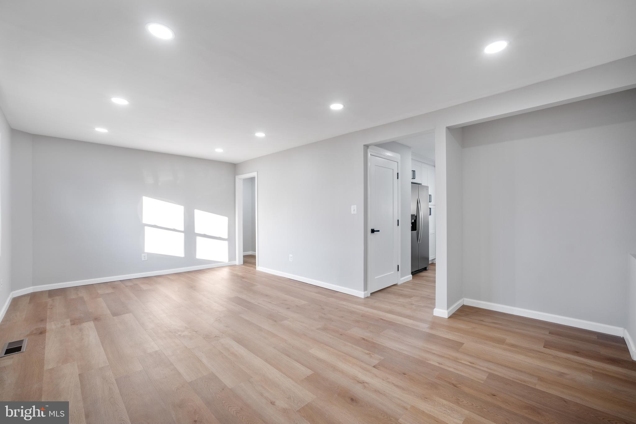497 Bruce Avenue Odenton, MD 21113 - Photo 7 of 38 a view of an empty room with wooden floor and window