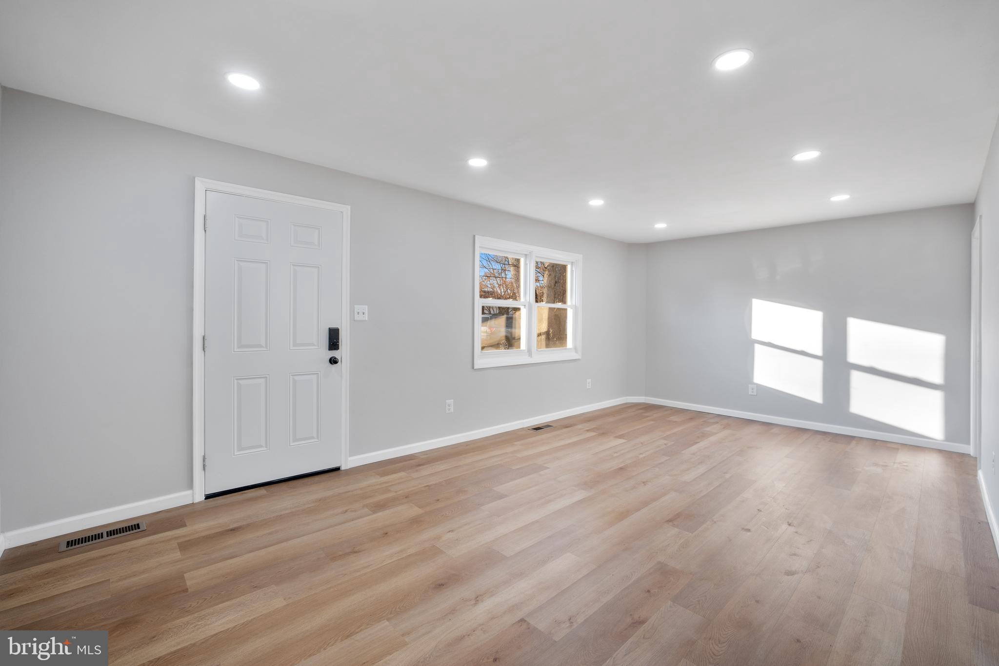 497 Bruce Avenue Odenton, MD 21113 - Photo 9 of 38 a view of empty room with wooden floor and fan