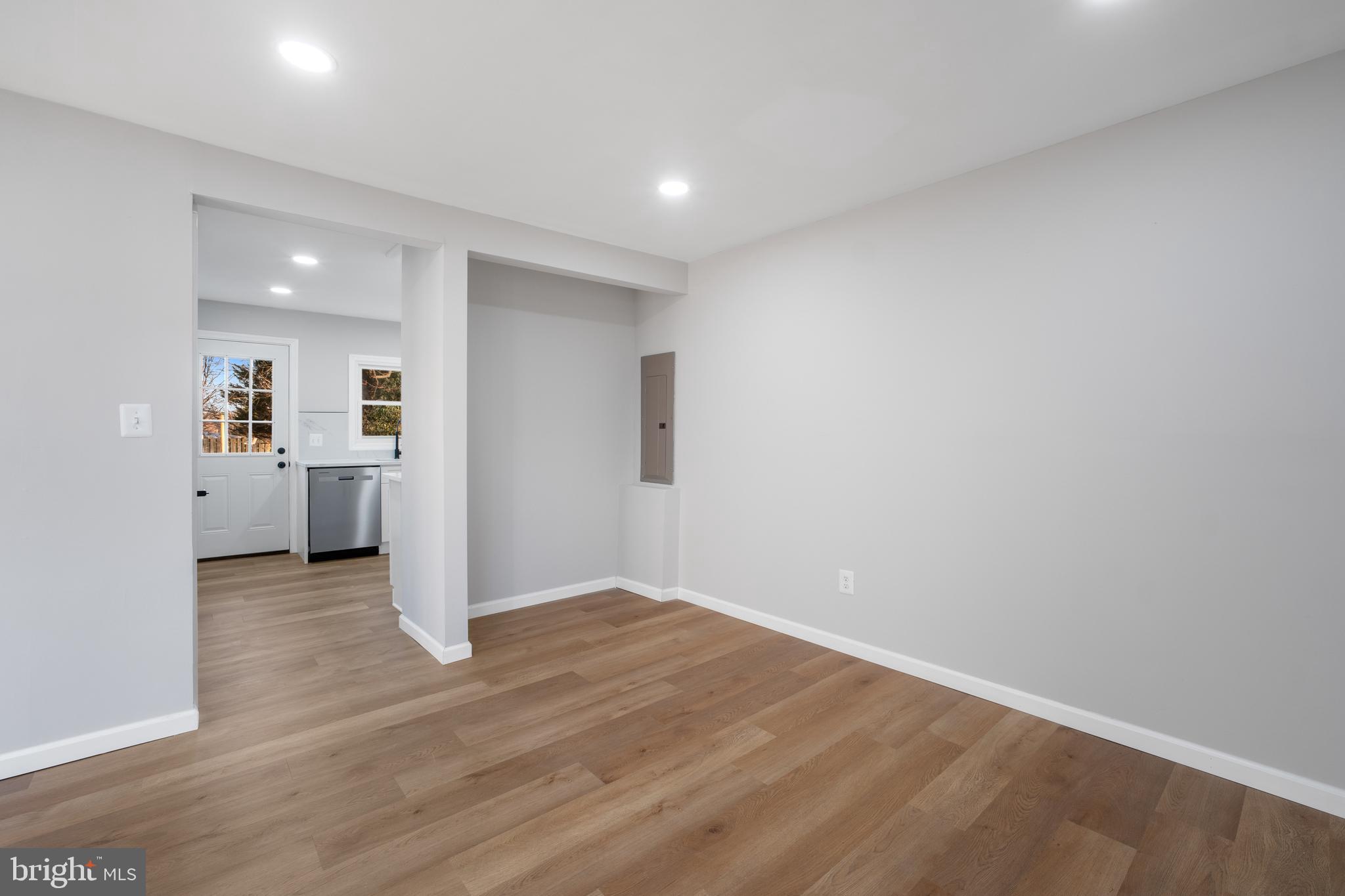 497 Bruce Avenue Odenton, MD 21113 - Photo 10 of 38 wooden floor in an empty room and a kitchen