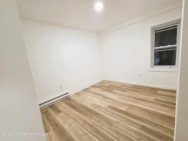 a view of a room with wooden floor and closet