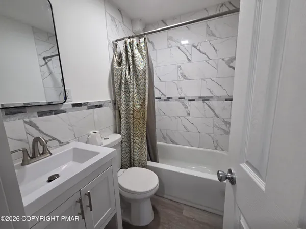 a bathroom with a sink toilet and shower