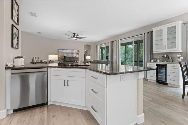 a kitchen with granite countertop white cabinets and white appliances