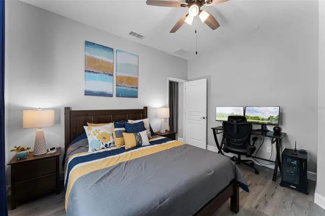 a bedroom with a bed and a chandelier