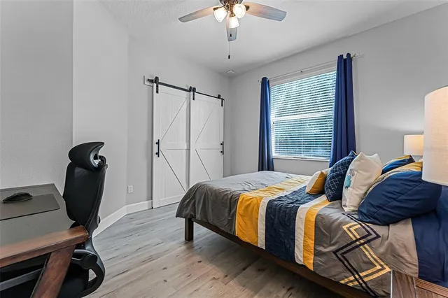 a bedroom with a bed and a chandelier