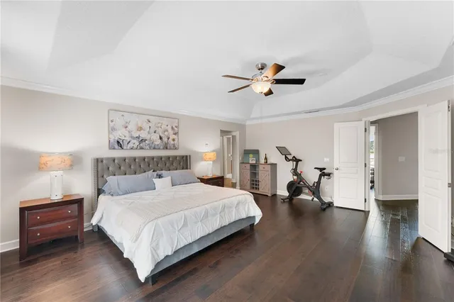 a bedroom with a bed and a chandelier