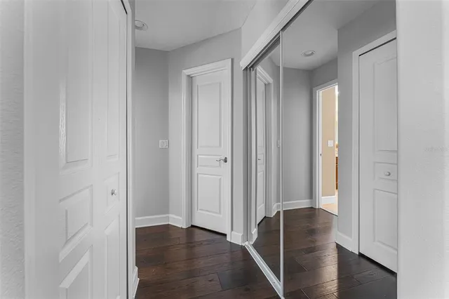 a view of a hallway with wooden floor