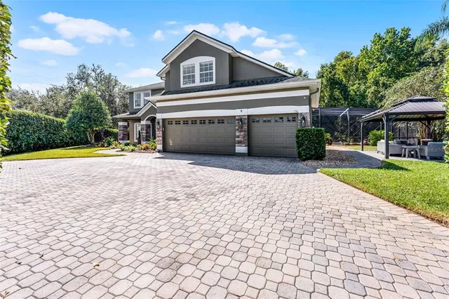a front view of house with yard and trees