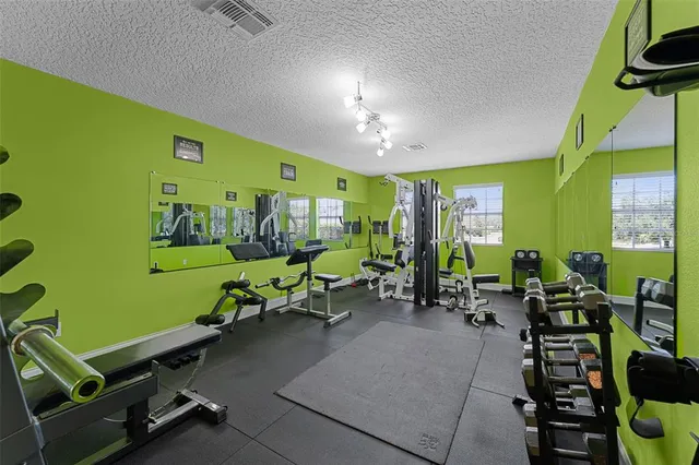a room with furniture pool table and windows